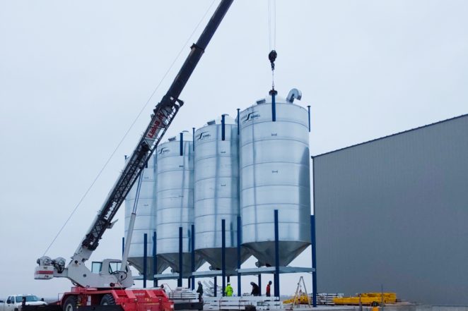 An experienced millwright contractor Peoria IL helping set up hopper seed systems